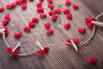 Red textile hearts connected by clothespin. Love concept
