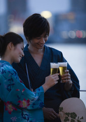 Couple in yukatas toasting