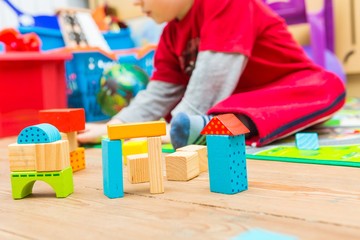 Small boy playing with wooden blocks