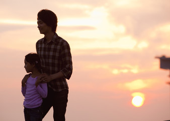 Father and daughter at sunset