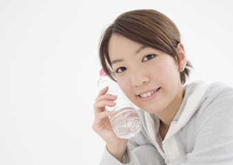 Young woman holding bottle of mineral water