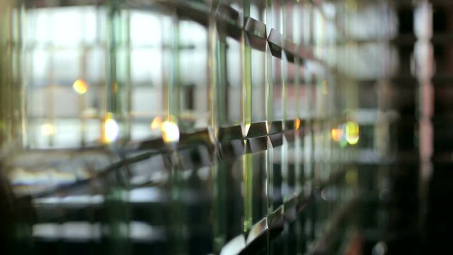 Silver background mosaic with light spots. Sparkling background. The mirror in the decor of the cafe. Slow motion.