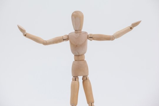 Wooden figurine standing with arms spread
