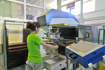 girl at work on the production of components for assembly of ovens