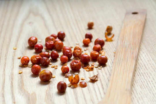 Dried chiltepin chilli pepper on wooden surface