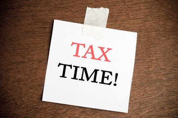 A white card with tax time text,finance planning