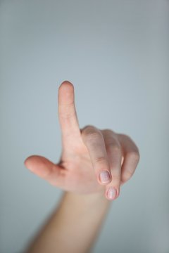 Hand of a woman pointing upwards