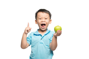 Asian baby boy holding and eating red apple, isolated on white