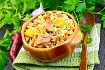 Rice with chicken and zucchini in bowl on dark board