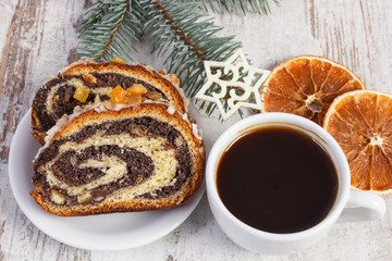 Poppy seeds cake, cup of coffee and spruce branches, dessert for Christmas