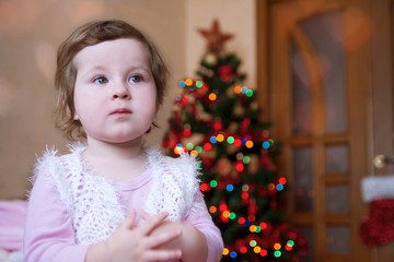 Cute baby girl over Christmas tree