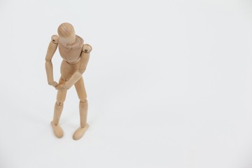 Wooden figurine standing with hands on knee
