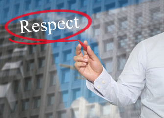 Hand of young businessman write the word Respect on skyscrapers