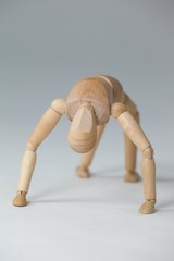 Wooden figurine exercising on floor