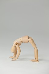 Wooden figurine exercising on floor