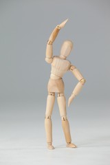 Wooden figurine exercising on floor