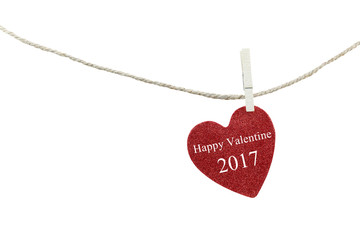 Red heart with text of Happy Valentine 2017 hanging on hemp rope