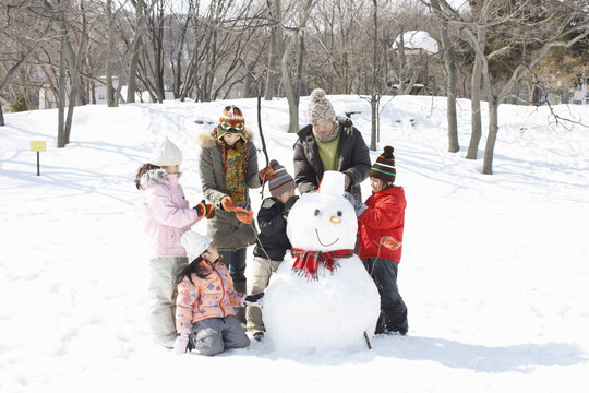 Family Making A Snowman