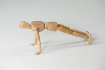 Wooden figurine performing push-ups