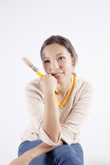 Young woman holding a painting brush