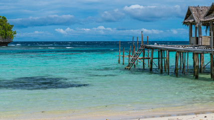 Beautiful Blue Lagoone with some Bamboo Huts, Kordiris Homestay, Palmtree in Front, Gam Island,...