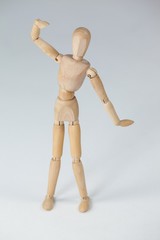 Wooden figurine standing with hand raised
