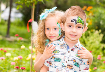 The boy and girl child with aqua make-up on happy birthday. Celebration concept and childhood, love