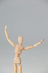 Wooden figurine standing with arms spread wide