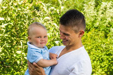 charming caucasian baby boy with father