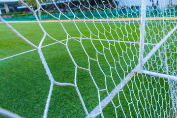 The nets of football goal with field artificial grass