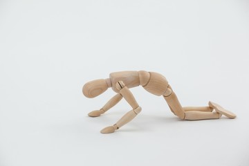 Wooden figurine exercising on floor