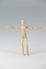 Wooden figurine standing with arms spread wide
