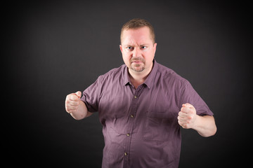 Handsome man doing different expressions in different sets of clothes: angry