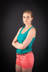 Beautiful woman doing different expressions in different sets of clothes: arms crossed