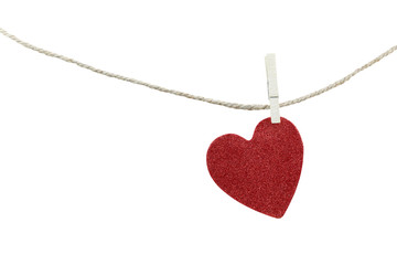 Red heart shape hanging on a hemp rope isolated on white backgro