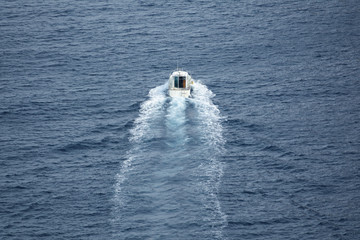 Small boat navigating, rear view, long shot