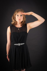 Fototapeta premium Beautiful woman doing different expressions in different sets of clothes: at attention