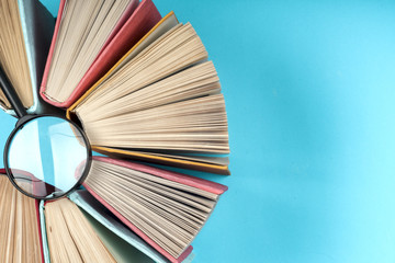 Top view of bright colorful hardback books in a circle.