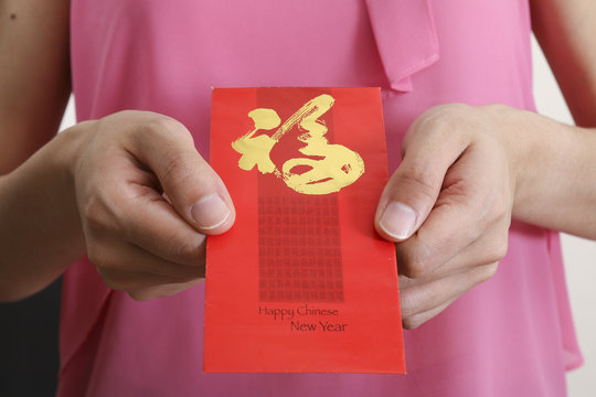 Lady holding chinese new year angpow money envelope in occasion of chinese new year