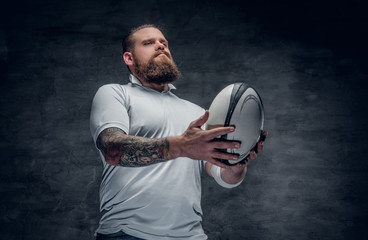 The bearded rugby player catching a game ball.