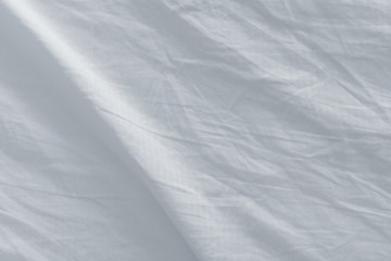 Naklejka premium Bed sheets after sleep, top view texture
