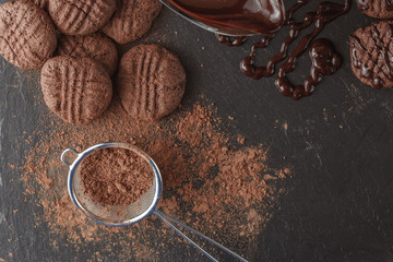 Dark chocolate with cocoa powder on table