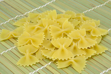 Farfalle. Raw pasta on bamboo mat