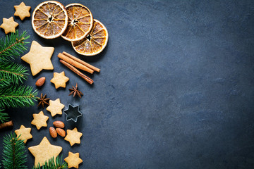 Christmas or New Year background with gingerbread cookies, stars shaped cookies, spices, almond...