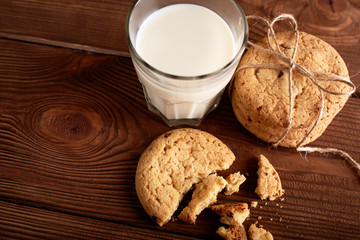Cookies and milk. Chocolate chip cookies and a glass of milk. Vintage look. Tasty cookies and glass of milk on rustic wooden background. Food, junk-food, culinary, baking and eating concept