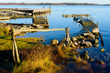 Calm and windless sea surround the old wooden piers in the archipelago on this winter day. Location...