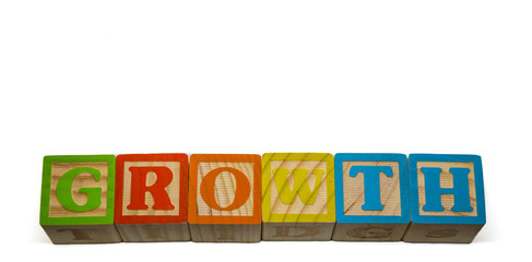 The word Growth constructed of wooden blocks on isolated white background