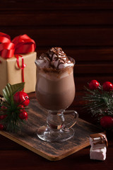 Christmas composition with hot cocoa, gift and fir-tree branch