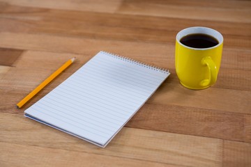 Coffee mug with notepad and pencil