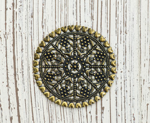 Vintage pendant on white wooden background